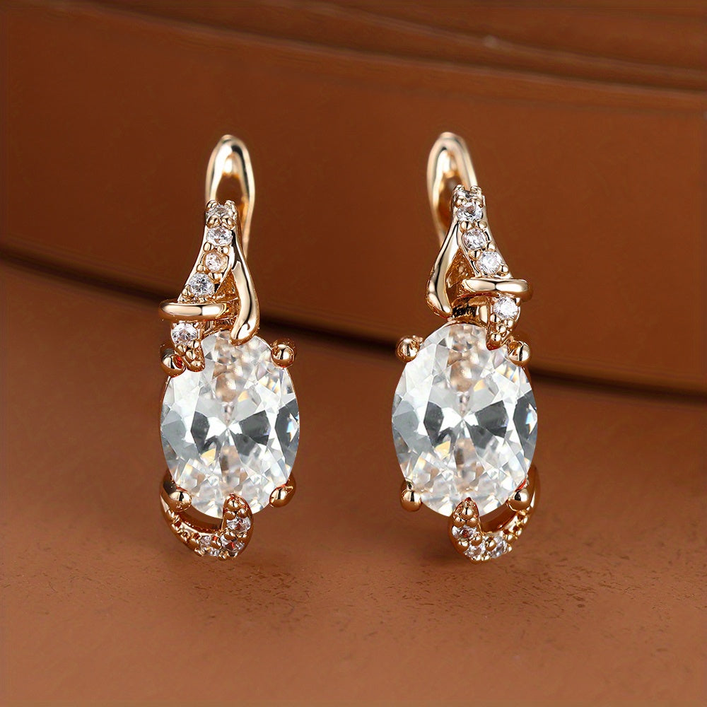 Elegant oval-cut crystal drop earrings with gold plating and sparkling accents, perfect for anniversaries or special occasions.