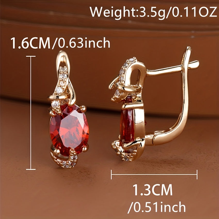 Red oval-cut stone earrings with gold claw setting, elegant drop design, perfect for anniversaries and daily wear.