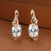 Elegant oval-cut crystal drop earrings with gold plating and sparkling accents, perfect for anniversaries or special occasions.