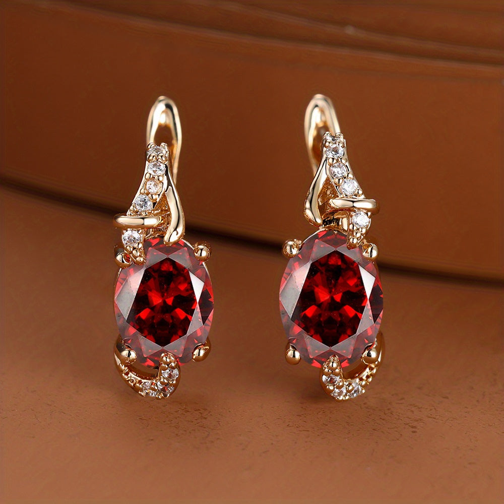 Elegant red oval-cut drop earrings with gold accents and sparkling embellishments for women.